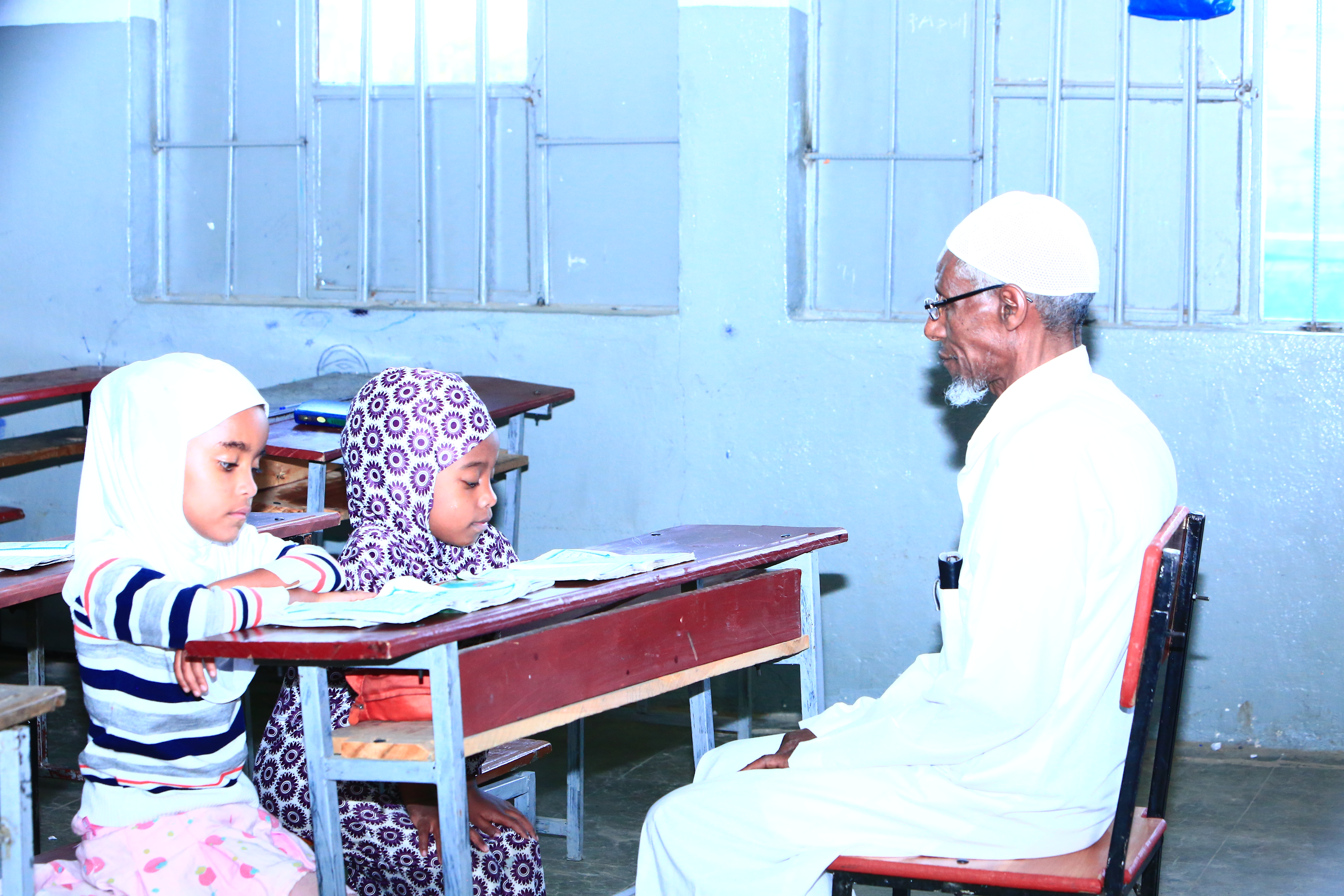 Students learning Quran in a classroom