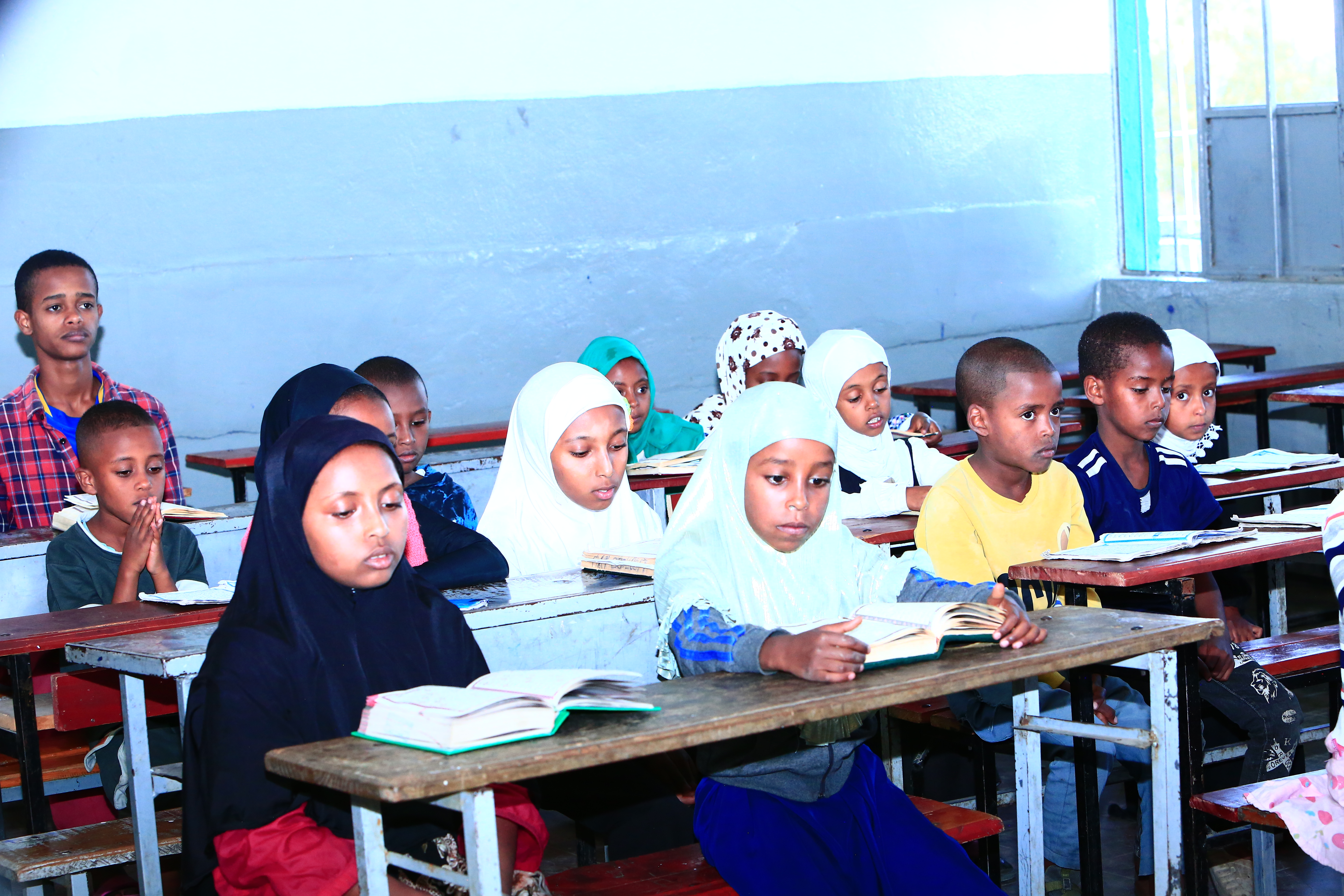 Students learning Quran in a classroom