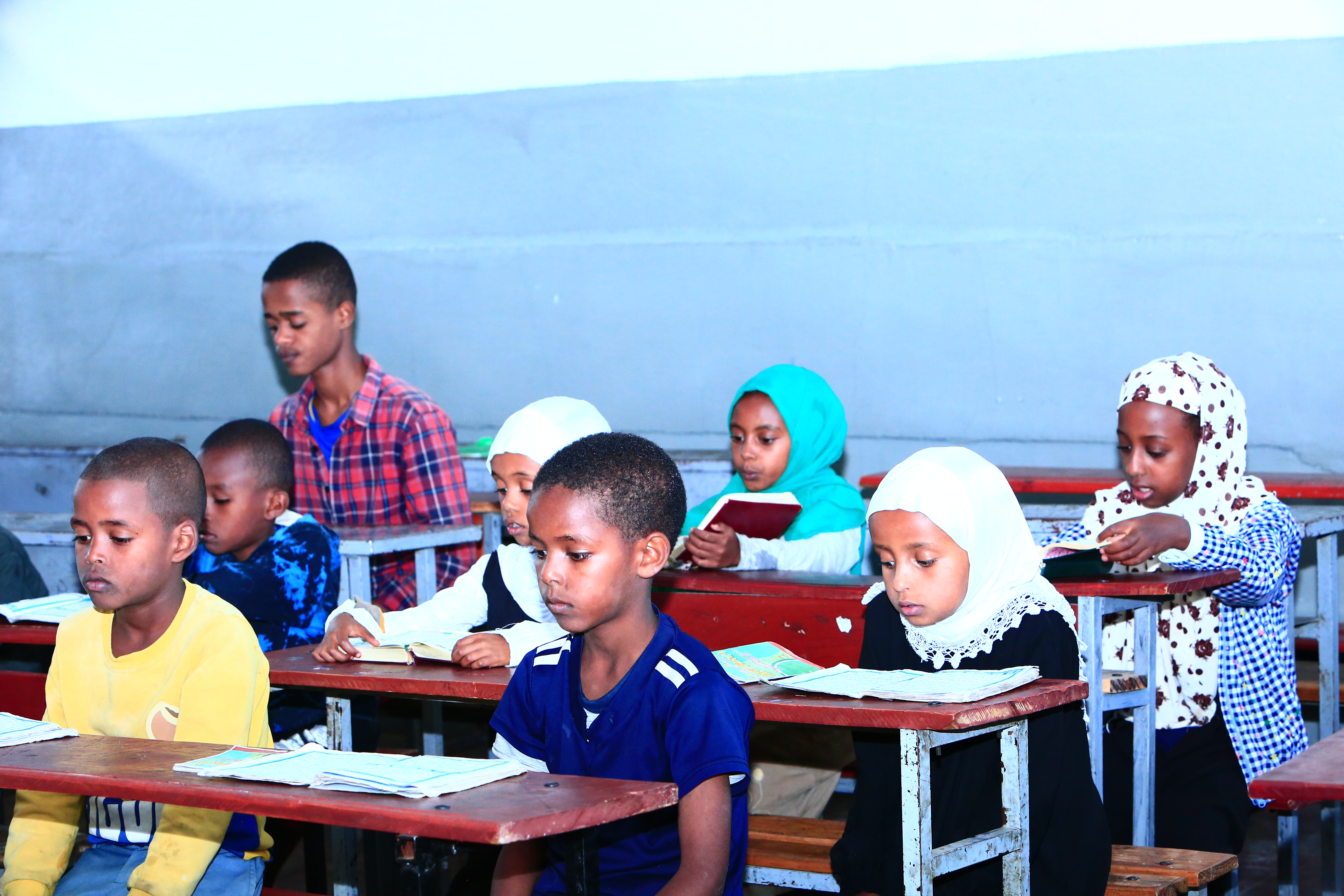 Students learning Quran in a classroom