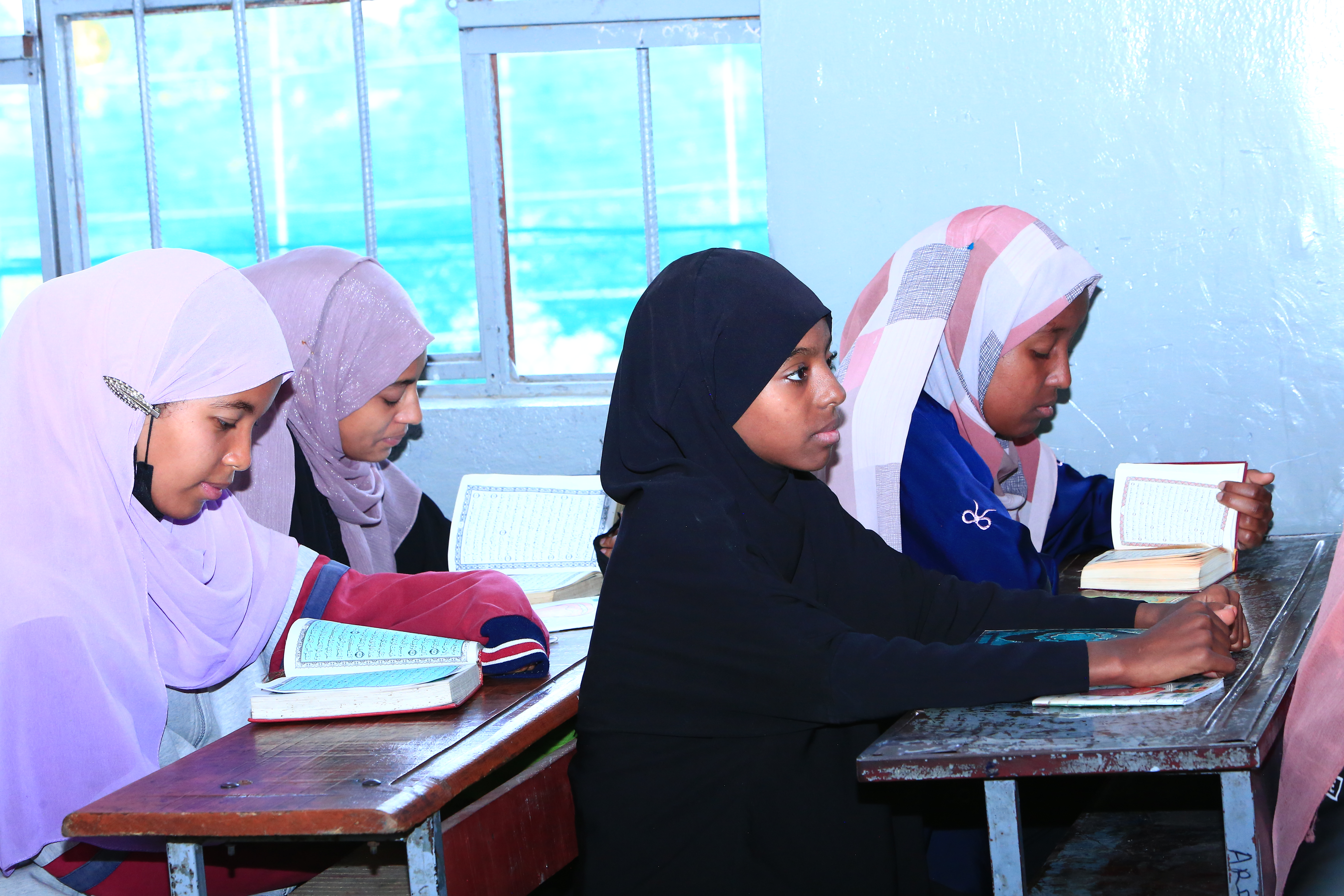 Students learning Quran in a classroom