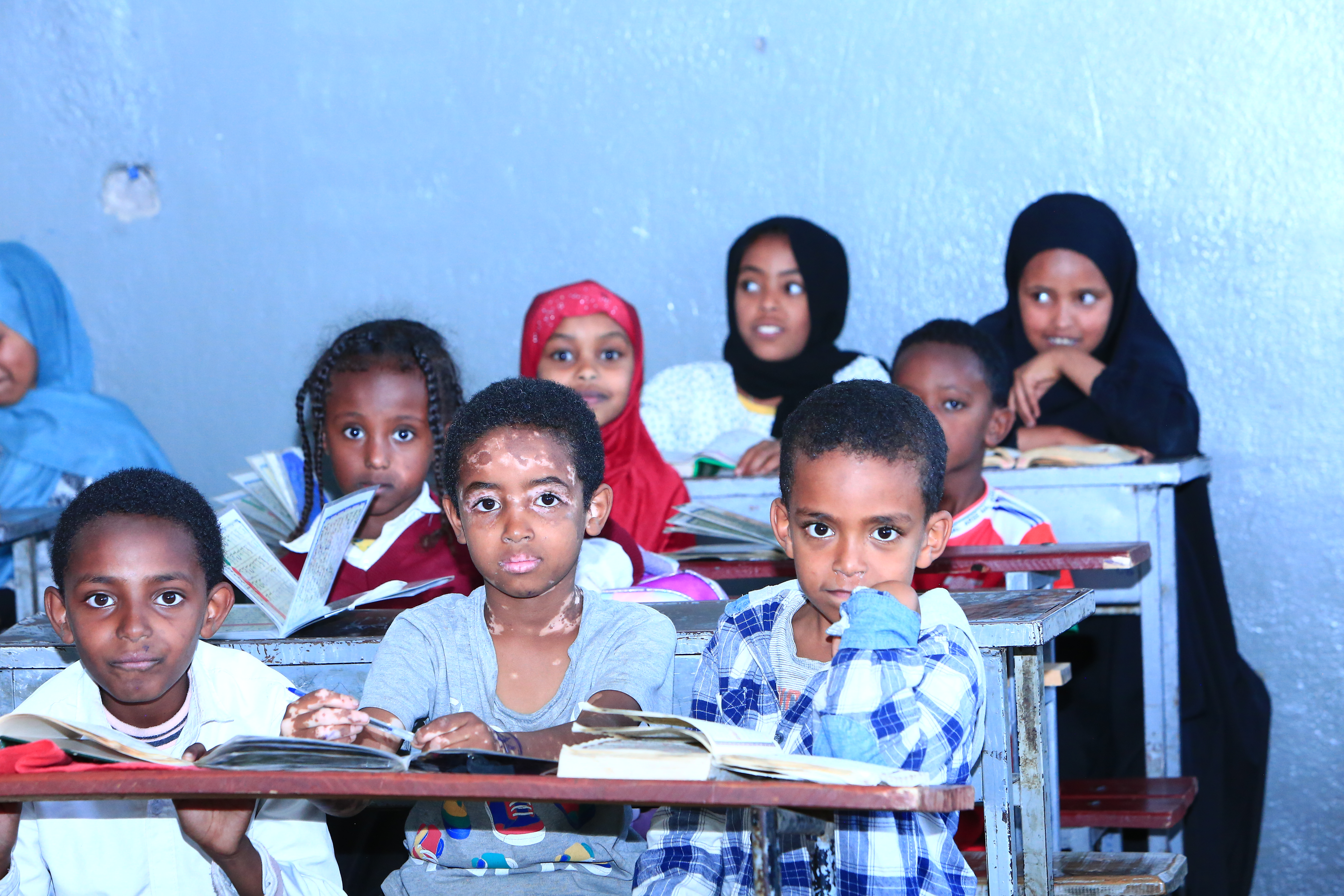 Students learning Quran in a classroom