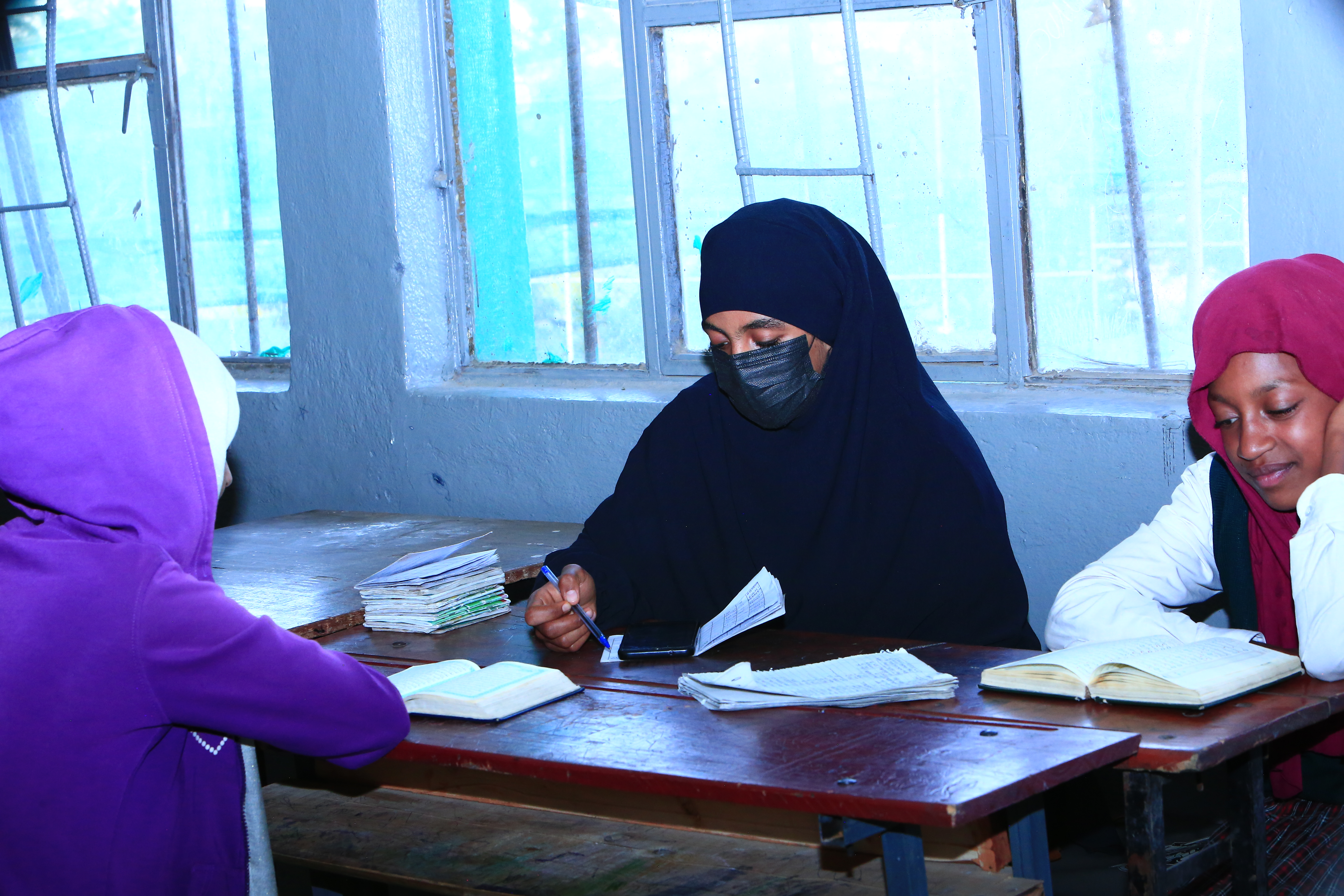 Students learning Quran in a classroom