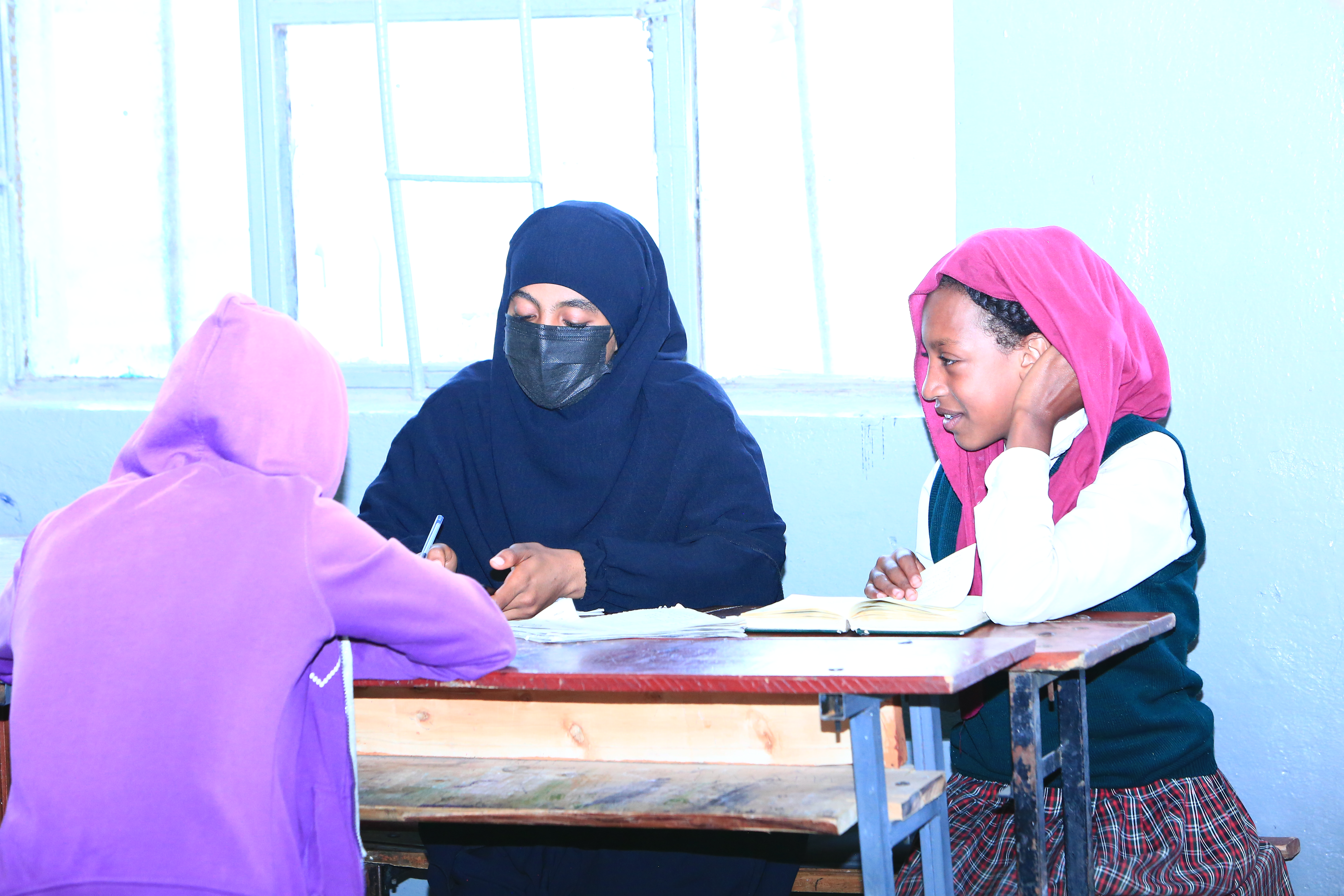 Students learning Quran in a classroom